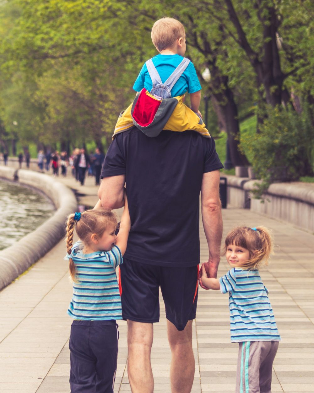 A parent with their kids on a riverside walk — evenings back