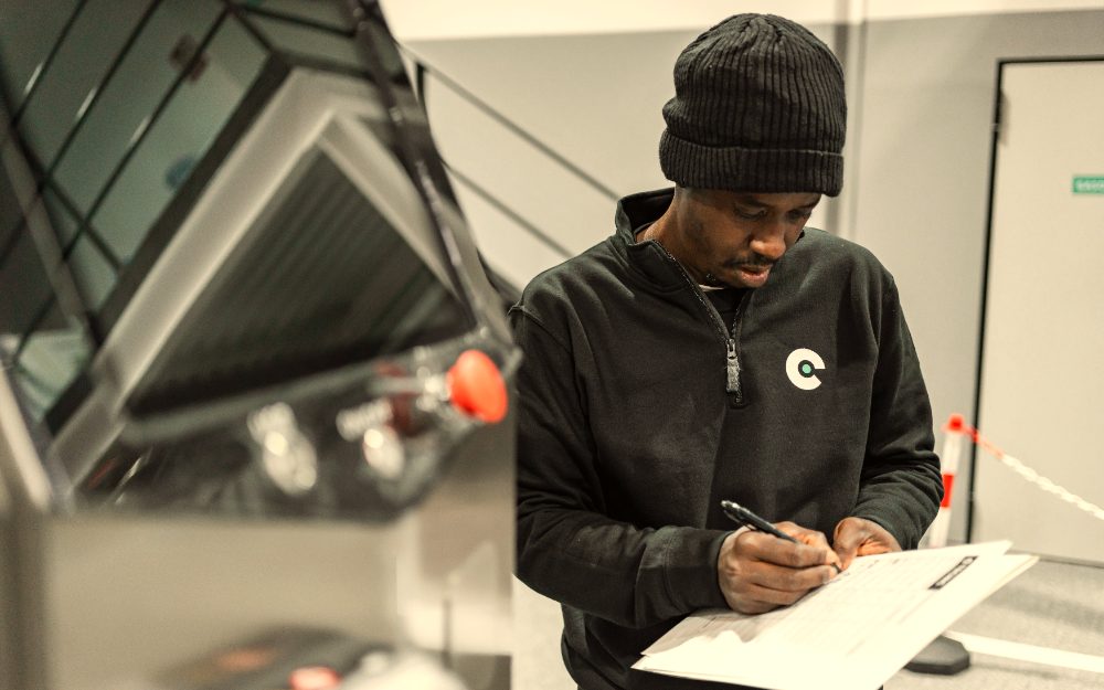 A service tech filling out a job sheet by hand